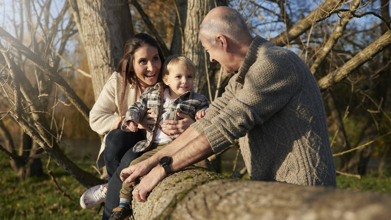 nutricia-grandfather-mother-son-playing-on-tree-trunk.jpg