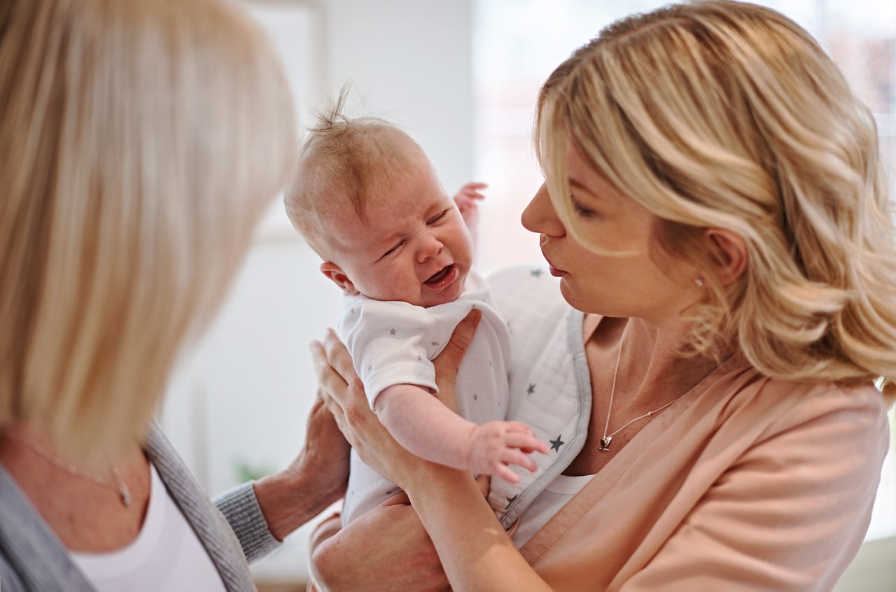 Web only - mum and grandma comforting crying baby colic