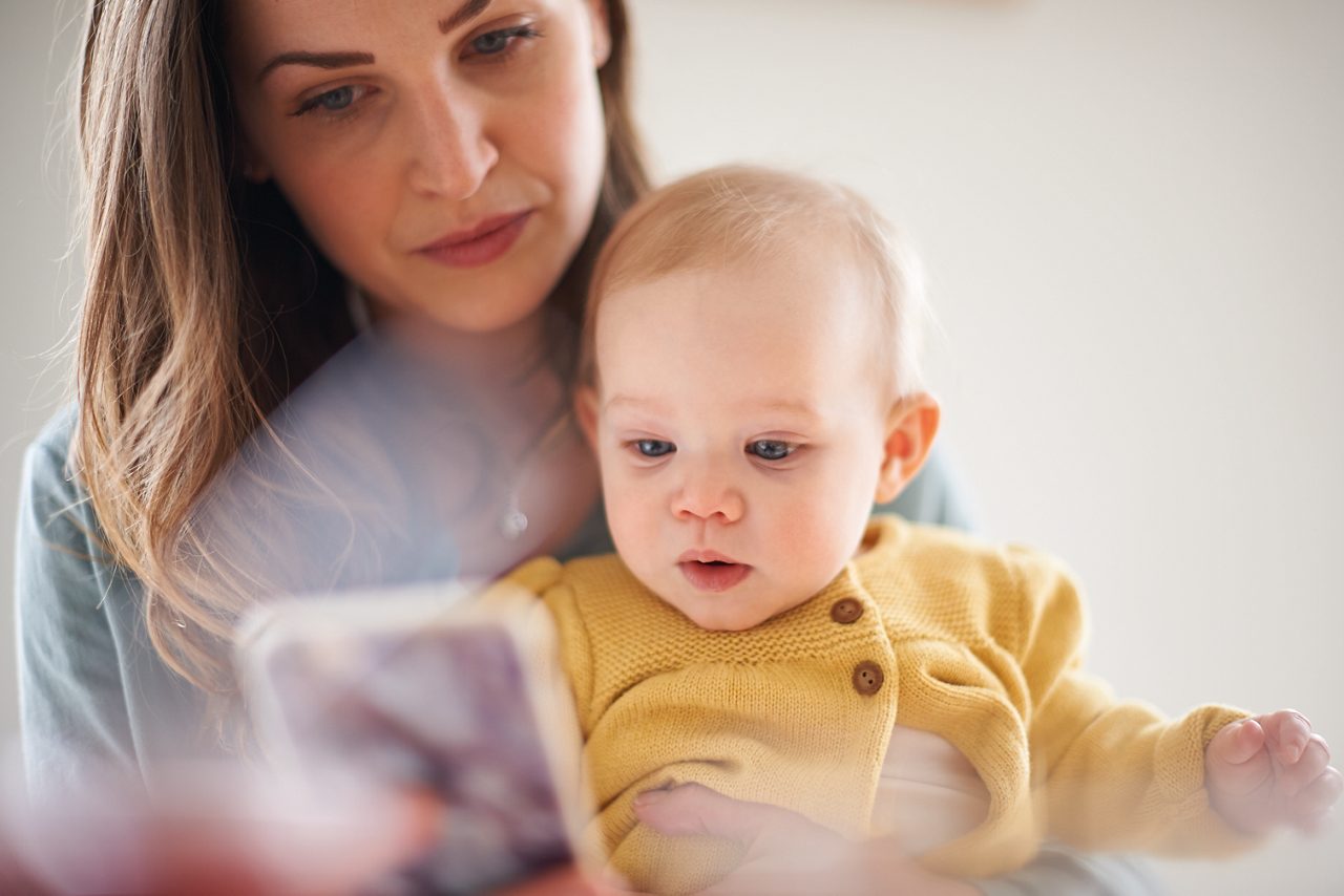 Web only - mum shows baby on lap phone bonding