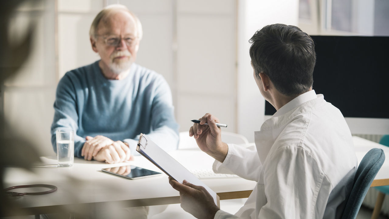 doctor-and-clipboard-with-male-patient-during-consultation