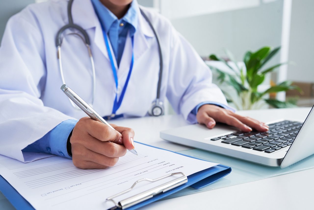 Docteur remplissant un document