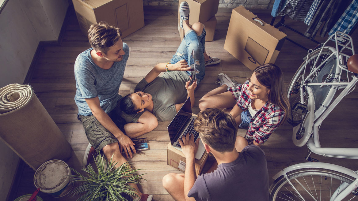 High angle view of relaxed people taking a break from relocating and using wireless technology.