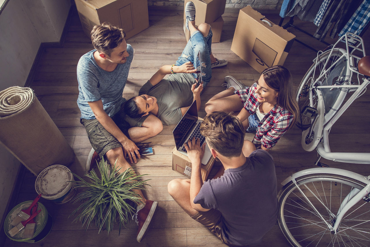 High angle view of relaxed people taking a break from relocating and using wireless technology.