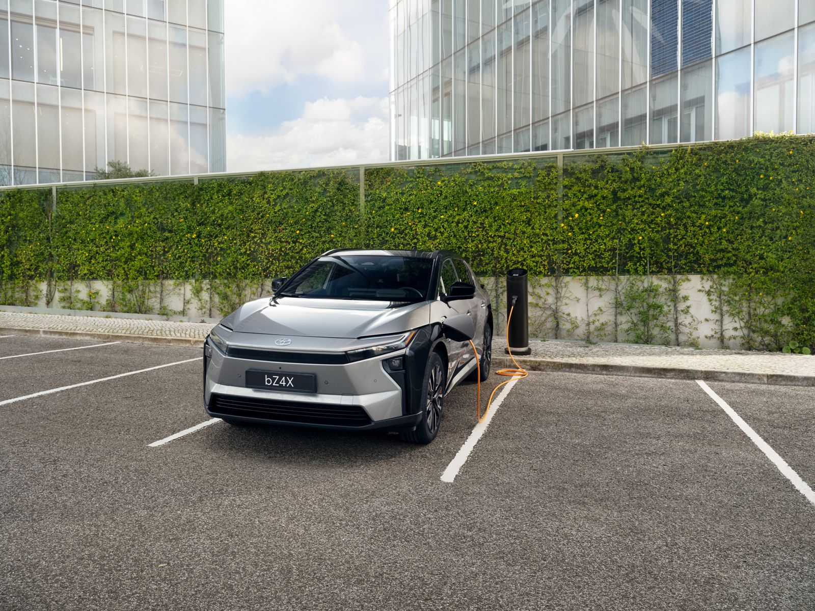 A Toyota bZ4X plugged in to a public charger